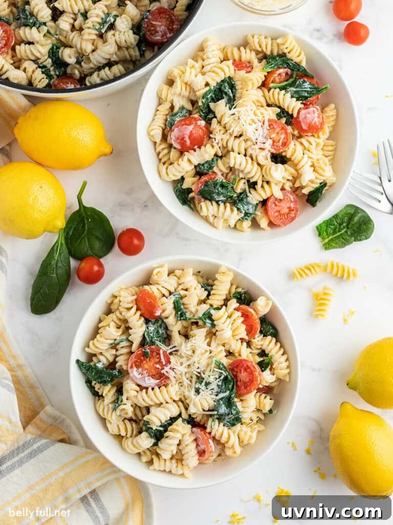 Creamy Lemon Pasta Recipe with Garlic and Parmesan 3 lemon pasta with tomatoes and spinach in 2 white serving bowls