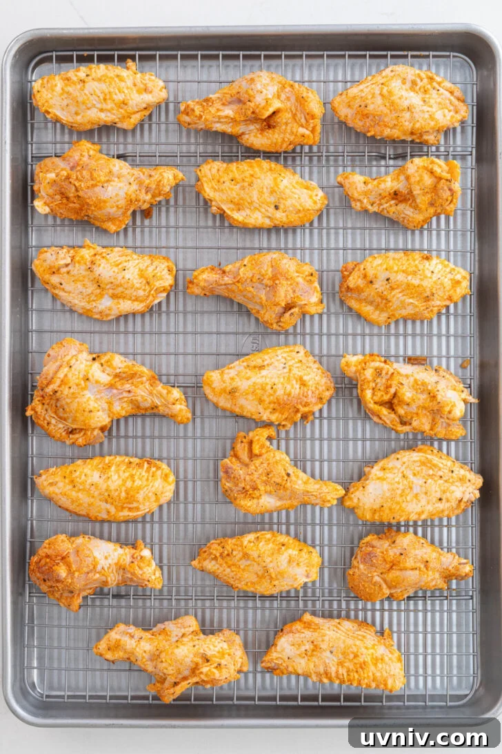 Mango Habanero Chicken Wings with Sticky Glaze 6 Seasoned wings on a baking rack.