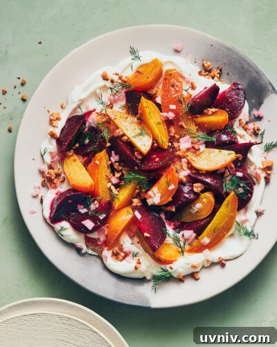 Roasted Beet and Labneh Salad with Mint and Pistachios 12 Labneh topped with roasted beets and fresh herbs on a light green table