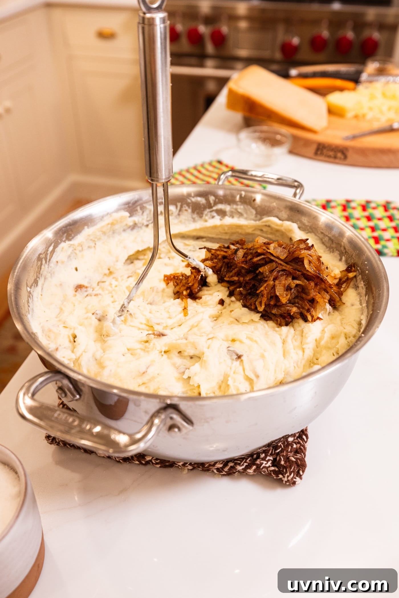 French Onion Potato Casserole Recipe with Melty Cheese 13 Large metal stockpot filled with mashed potatoes and caramelized onions before bing mixed together.