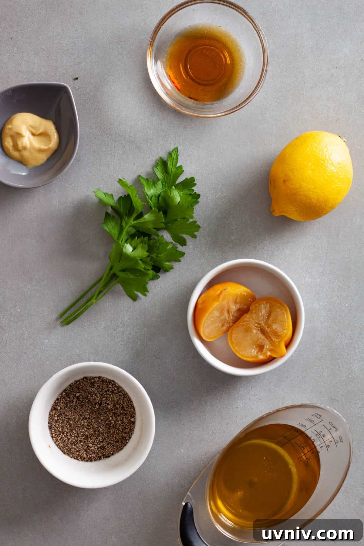 Zesty Preserved Lemon Vinaigrette Recipe for Salads & Marinades 3 Ingredients for a preserved lemon vinaigrette on a gray table.