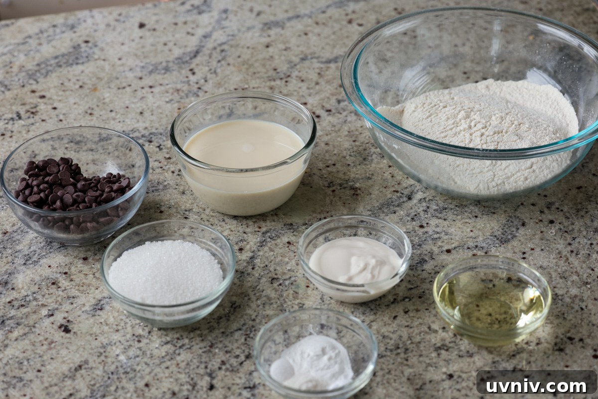chocolate chip muffin ingredients in bowls on the kitchen counter