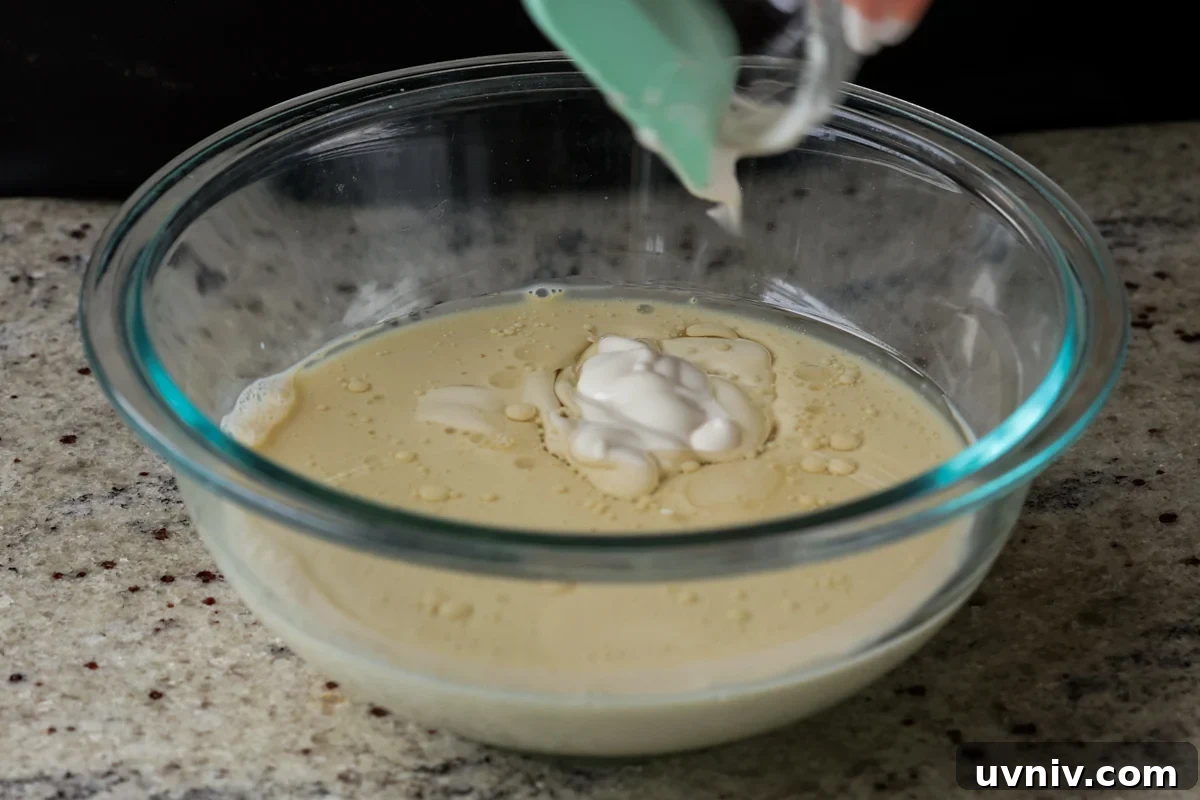 adding non-dairy yogurt to the bowl of wet ingredients