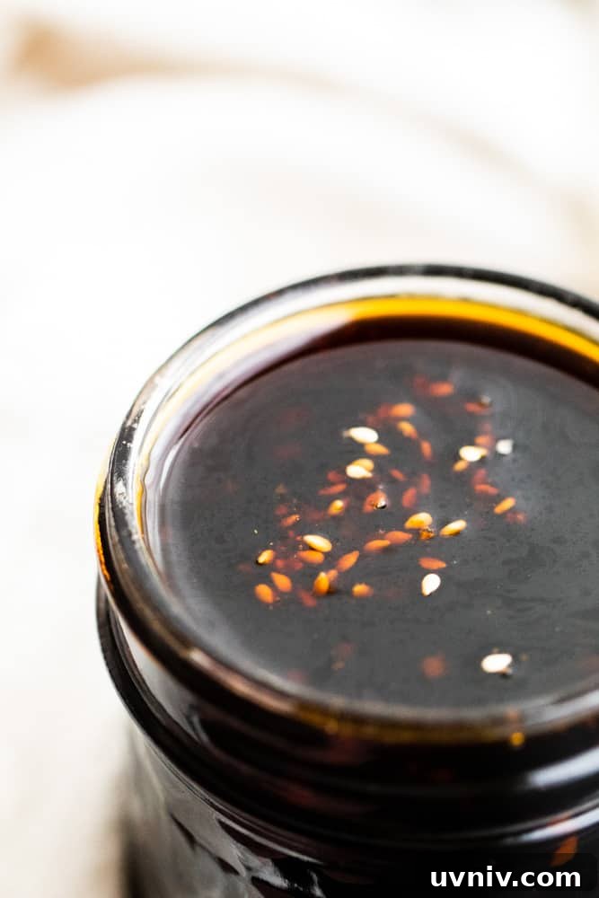 Homemade teriyaki sauce Close up shot of teriyaki sauce in a mason jar with white background.