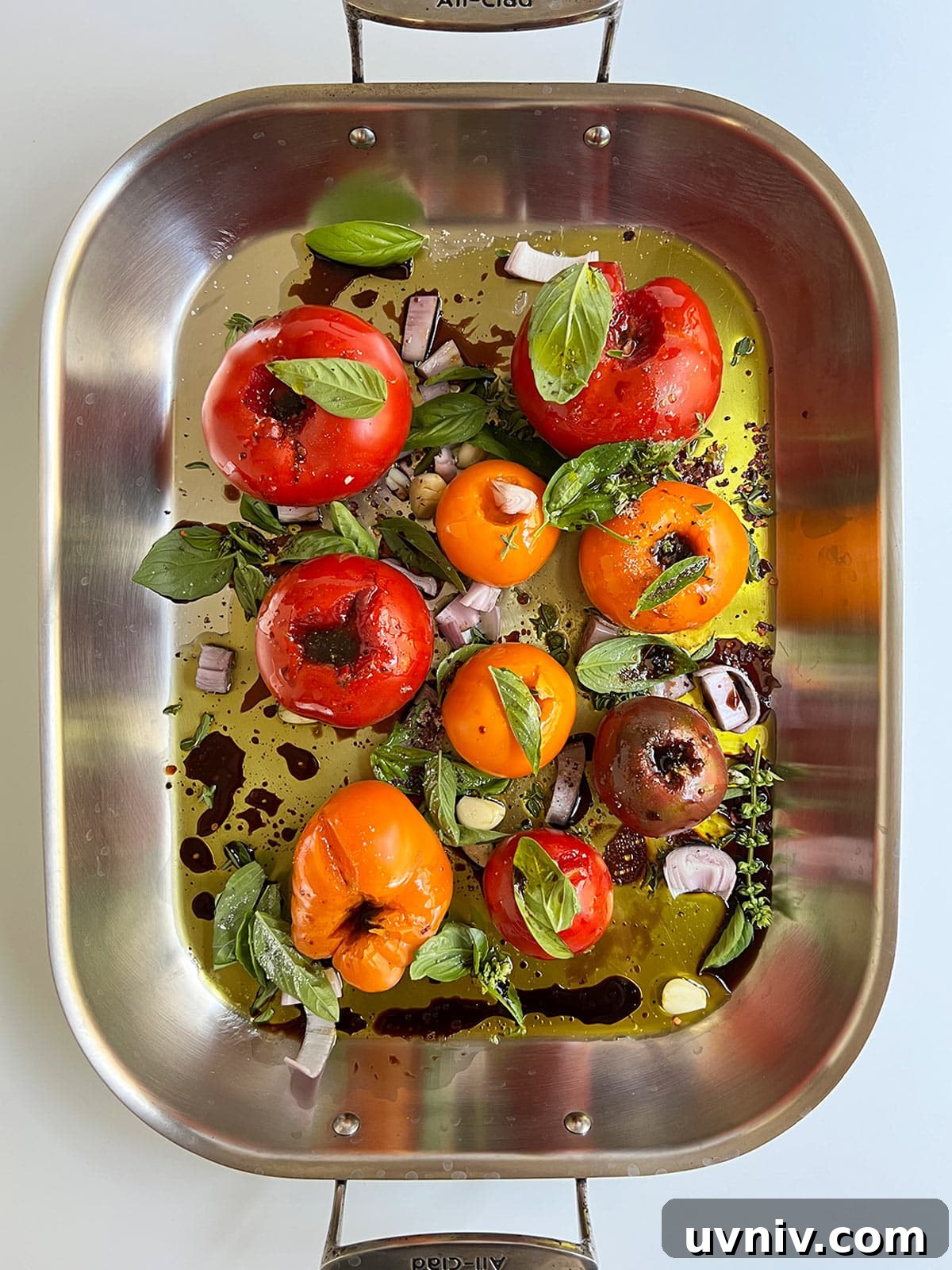 Roasted Tomato Sauce Recipe — Rich Flavor in Minutes 4 Tomatoes and other sauce ingredients in a large roasting pan ready to go in the oven.