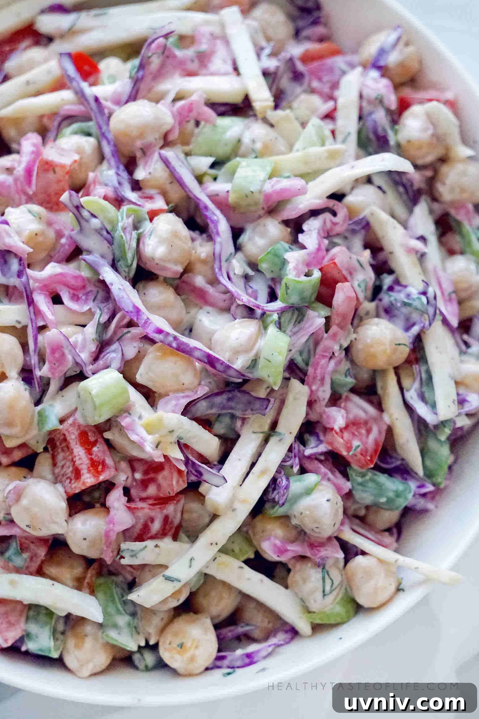 Creamy Vegan Chickpea & Cabbage Salad Recipe 6 Assembled chickpea salad with cabbage and veggies tossed with a creamy dressing.