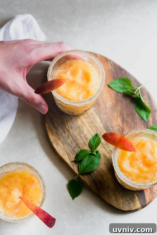 Strawberry Peach Wine Slushies - These fun summer drinks are made with just 4 ingredients - moscato, ice, frozen peaches and frozen strawberries. So easy to make and incredibly delicious! Perfect for any summer gathering Strawberry Peach Wine Slushies
