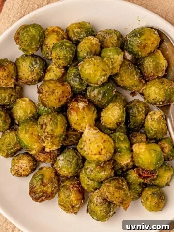 Brussels sprouts with a serving spoon on a plate.