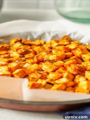 air fried sweet potato cubes in a basket on a blue cloth
