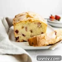 Strawberry Rhubarb Layer Cake Recipe for Summer Baking 4 cross-section of strawberry rhubarb cake on a cake plate.