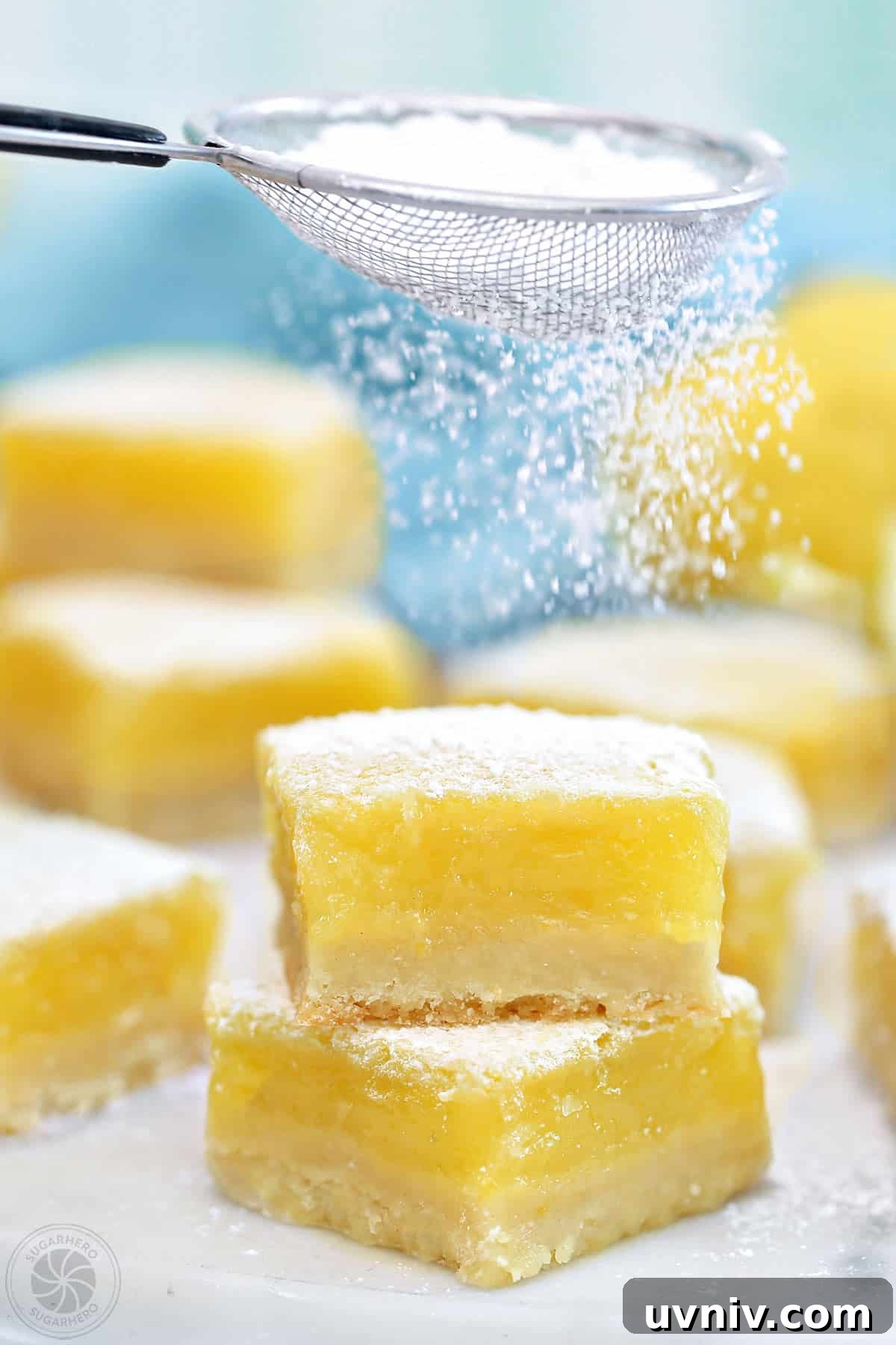 Zesty Lemon Bars: Classic Tangy Dessert Bar Recipe 2 Powdered sugar being sifted over a lemon bar.