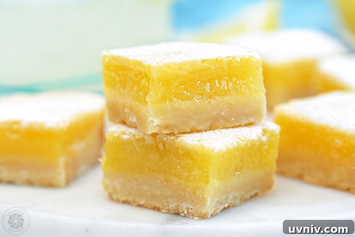 Zesty Lemon Bars: Classic Tangy Dessert Bar Recipe 5 Two stacked lemon bars.