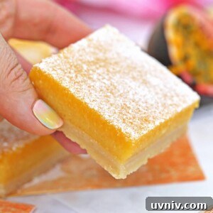 Zesty Lemon Bars: Classic Tangy Dessert Bar Recipe 6 Close up of Passion Fruit Bar held by a hand.