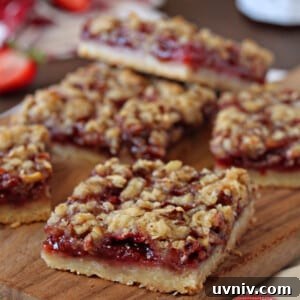 Zesty Lemon Bars: Classic Tangy Dessert Bar Recipe 10 Strawberry Basil Crumb Bars cut in squares on a cutting board.