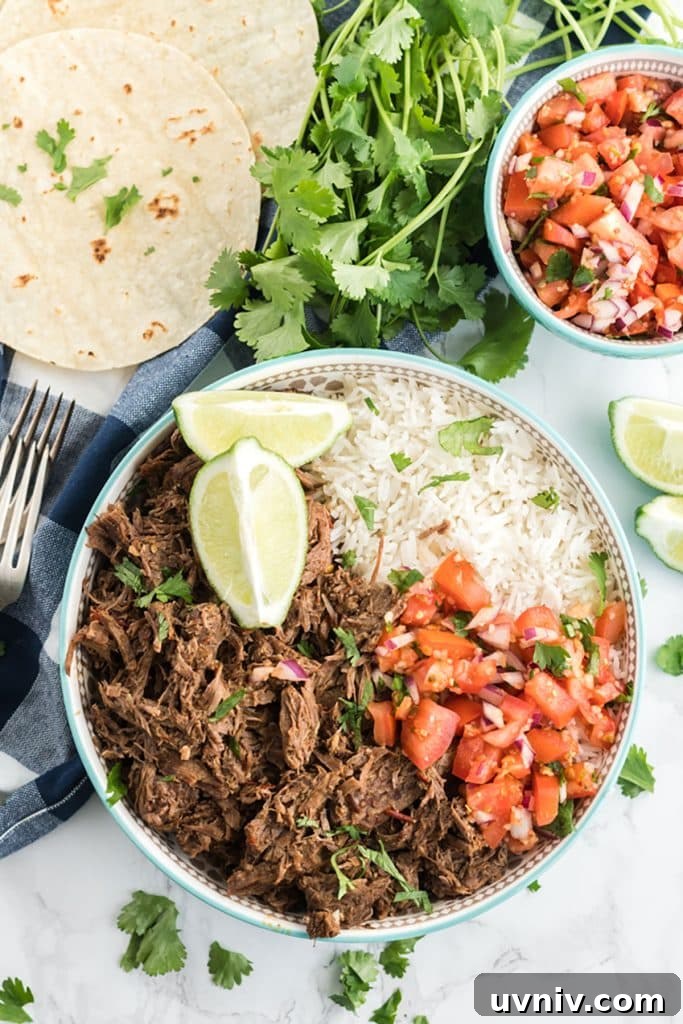Chipotle Beef Barbacoa Recipe: Smoky Slow-Cooked Mexican Beef 2 Shredded barbacoa beef with rice and pico de gallo in a white bowl