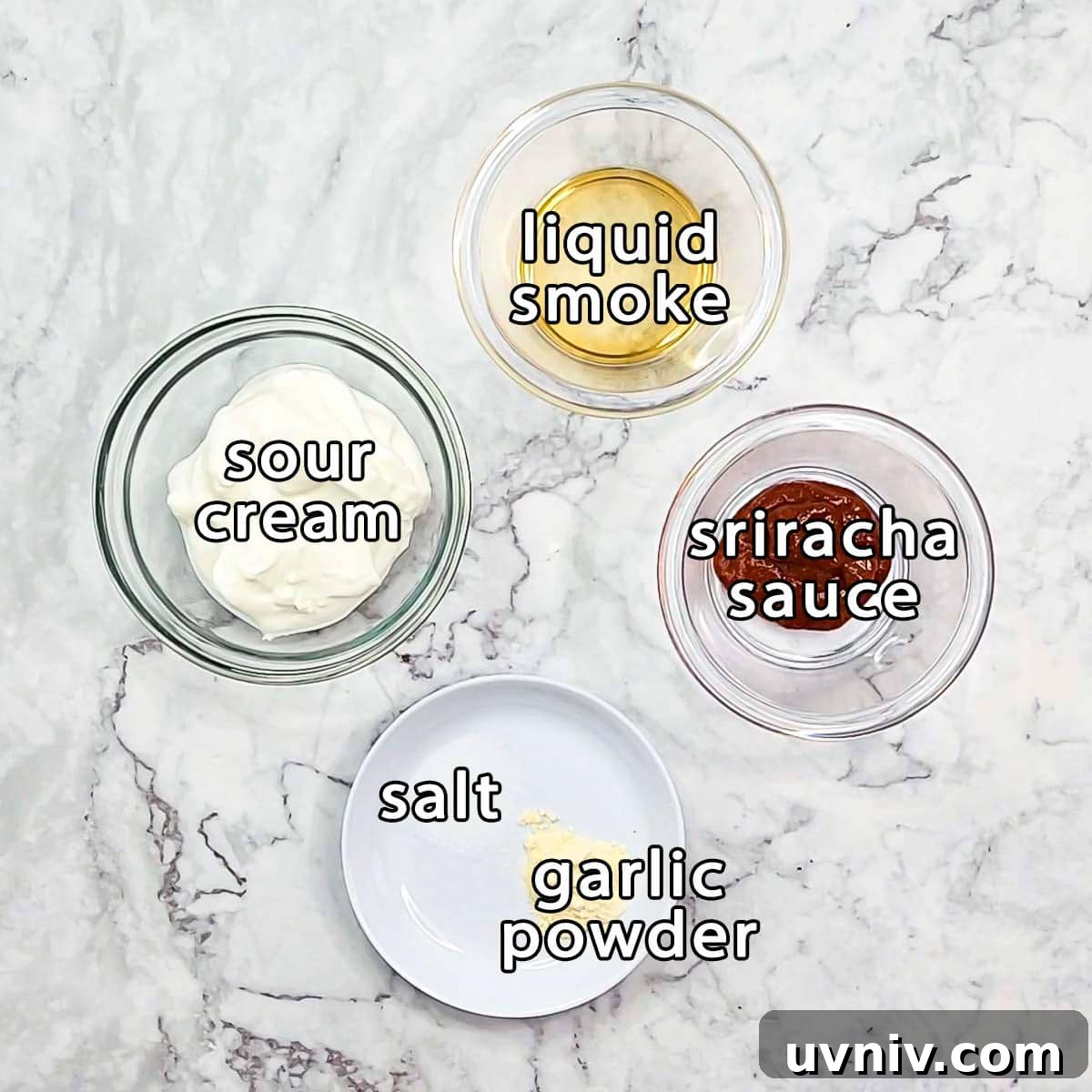 Creamy Sriracha Sauce Recipe for Burgers, Wraps & Sandwiches 3 Overhead shot of ingredients - liquid smoke, sriracha sauce, sour cream, salt, and garlic powder.