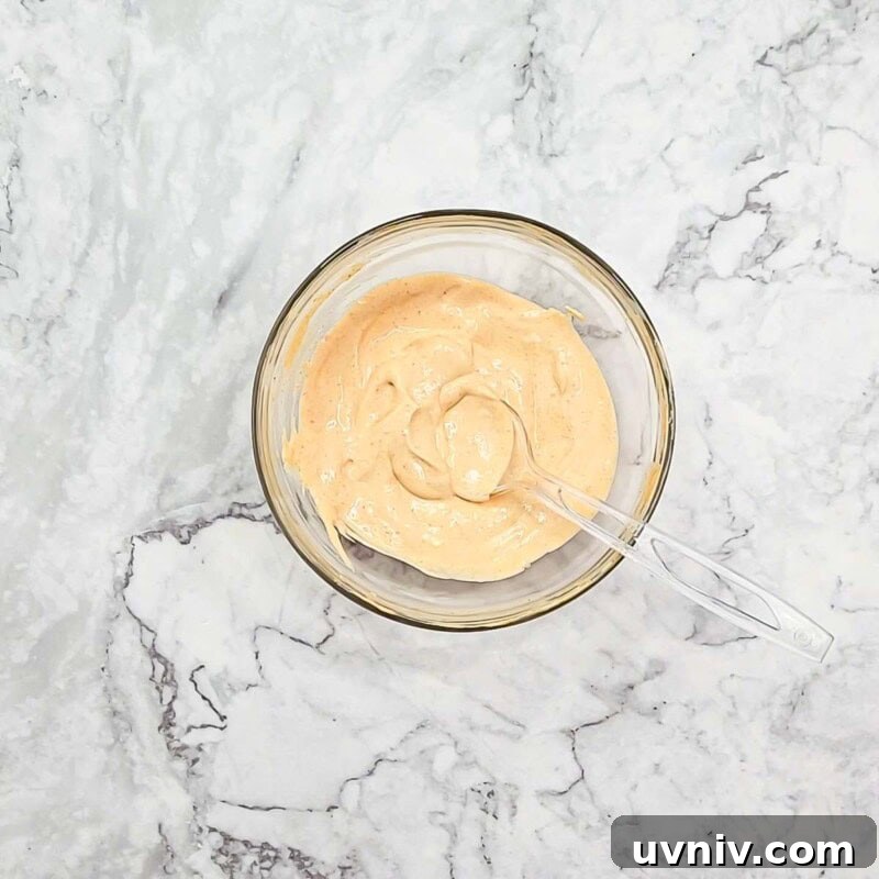 Creamy Sriracha Sauce Recipe for Burgers, Wraps & Sandwiches 5 Overhead view of process shot 2 - mix the ingredients thoroughly.