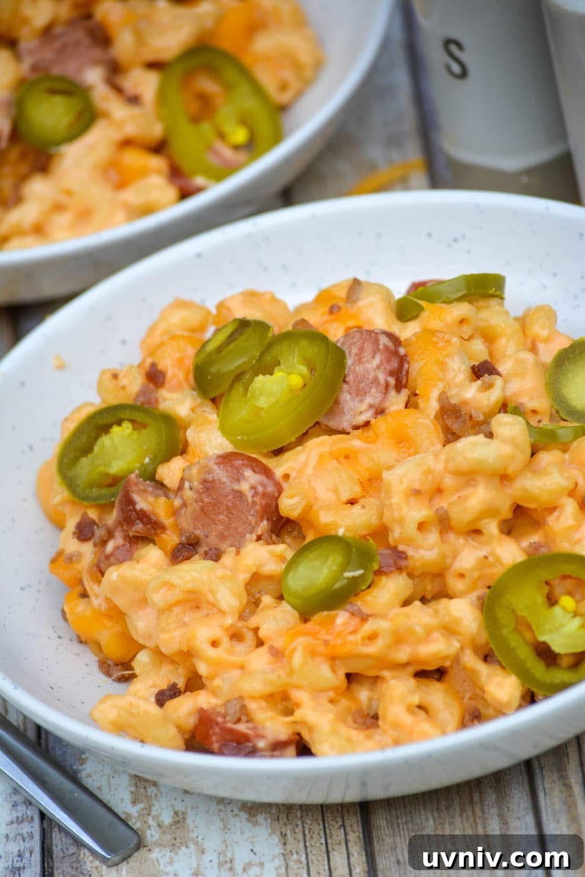 Firehouse-Style Macaroni and Cheese Recipe 2 firehouse mac and cheese in two white bowls topped with sliced jalapenos