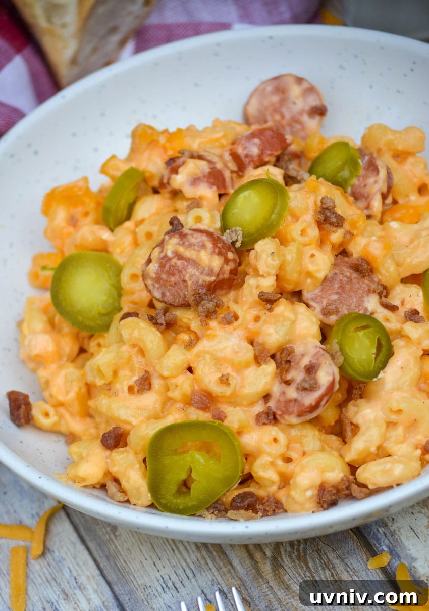 Firehouse-Style Macaroni and Cheese Recipe 3 firehouse mac and cheese in two white bowls topped with sliced jalapenos