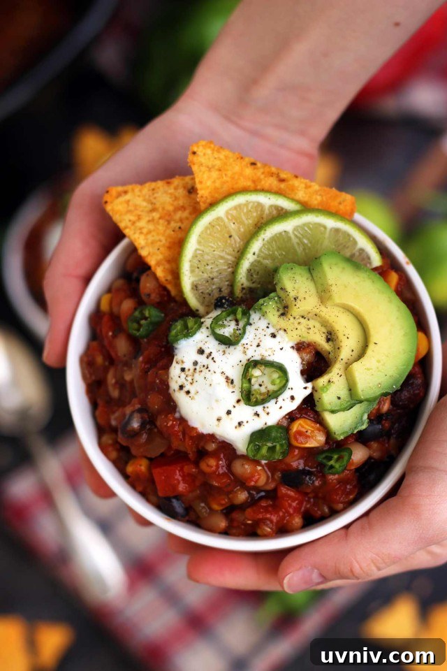 Hands Holding a Bowl of Chili