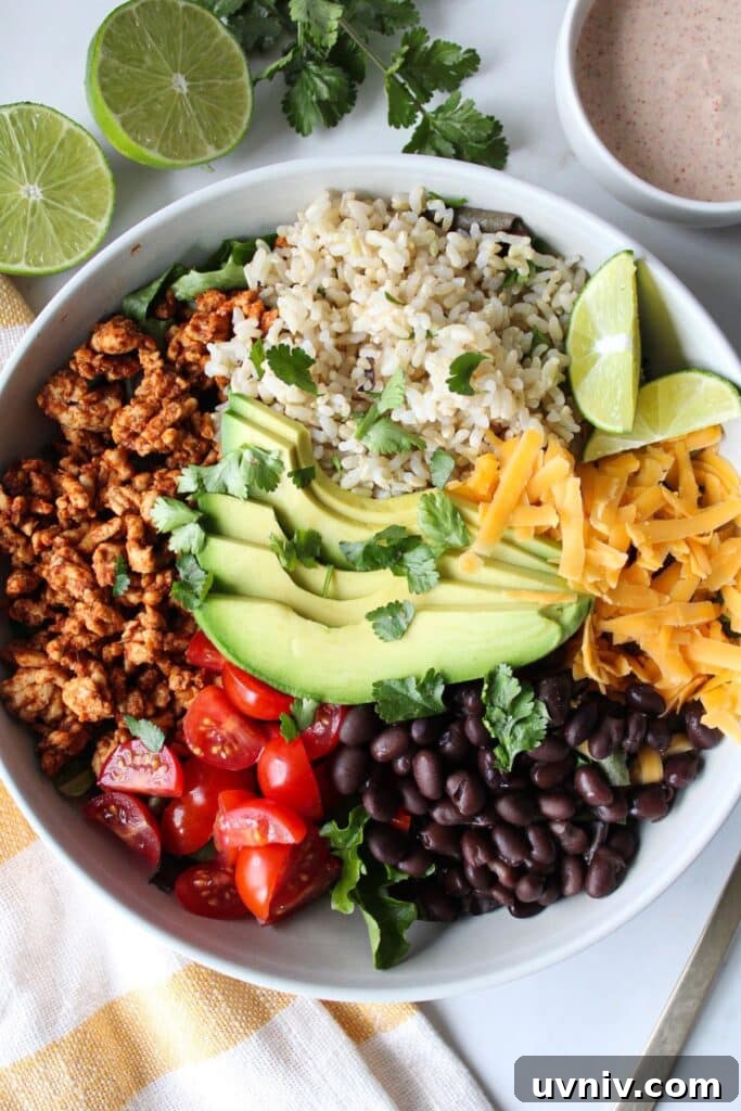 Taco Rice Bowl with Seasoned Beef, Salsa & Avocado 2 A taco rice bowl with ground turkey, rice, avocado, tomato, black beans, and shredded cheese with a creamy taco dressing on the side.