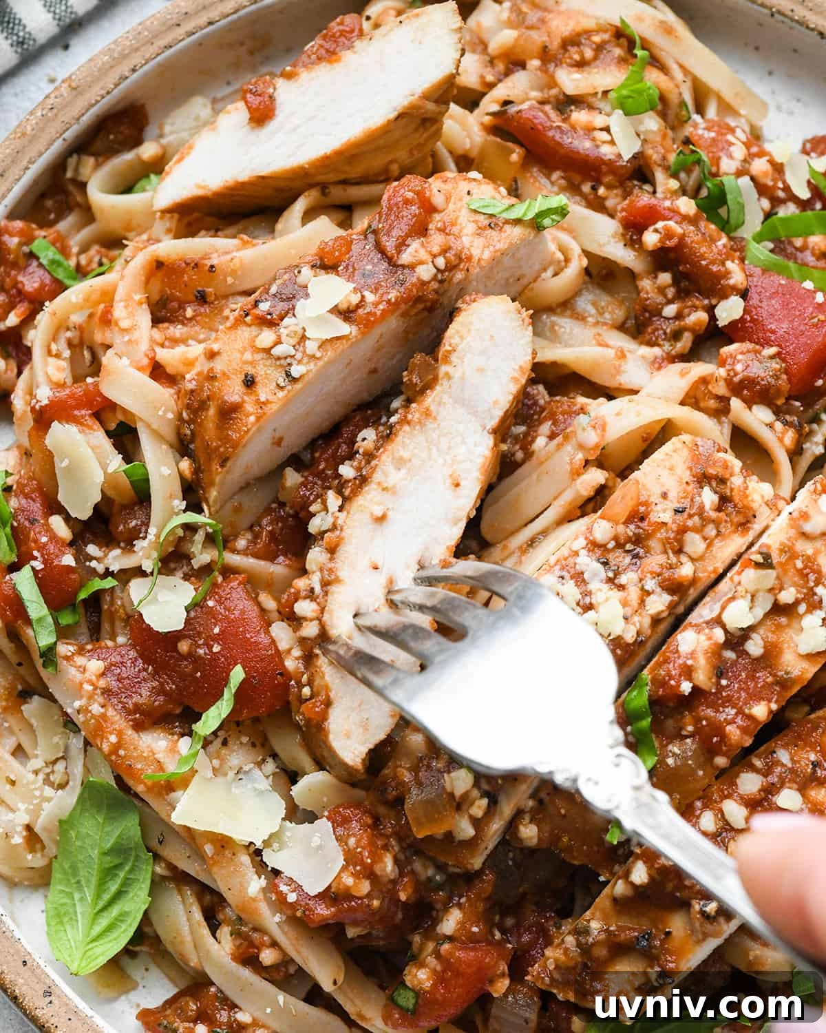 Slow Cooker Italian Chicken Recipe for Tender, Flavorful Meals 3 Slow Cooker Italian Chicken cut into strips on top of pasta on a plate
