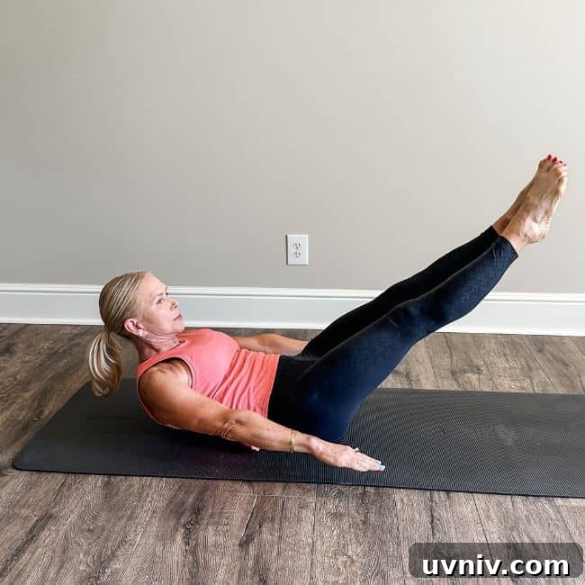 Woman performing Pilates 100 exercise at home