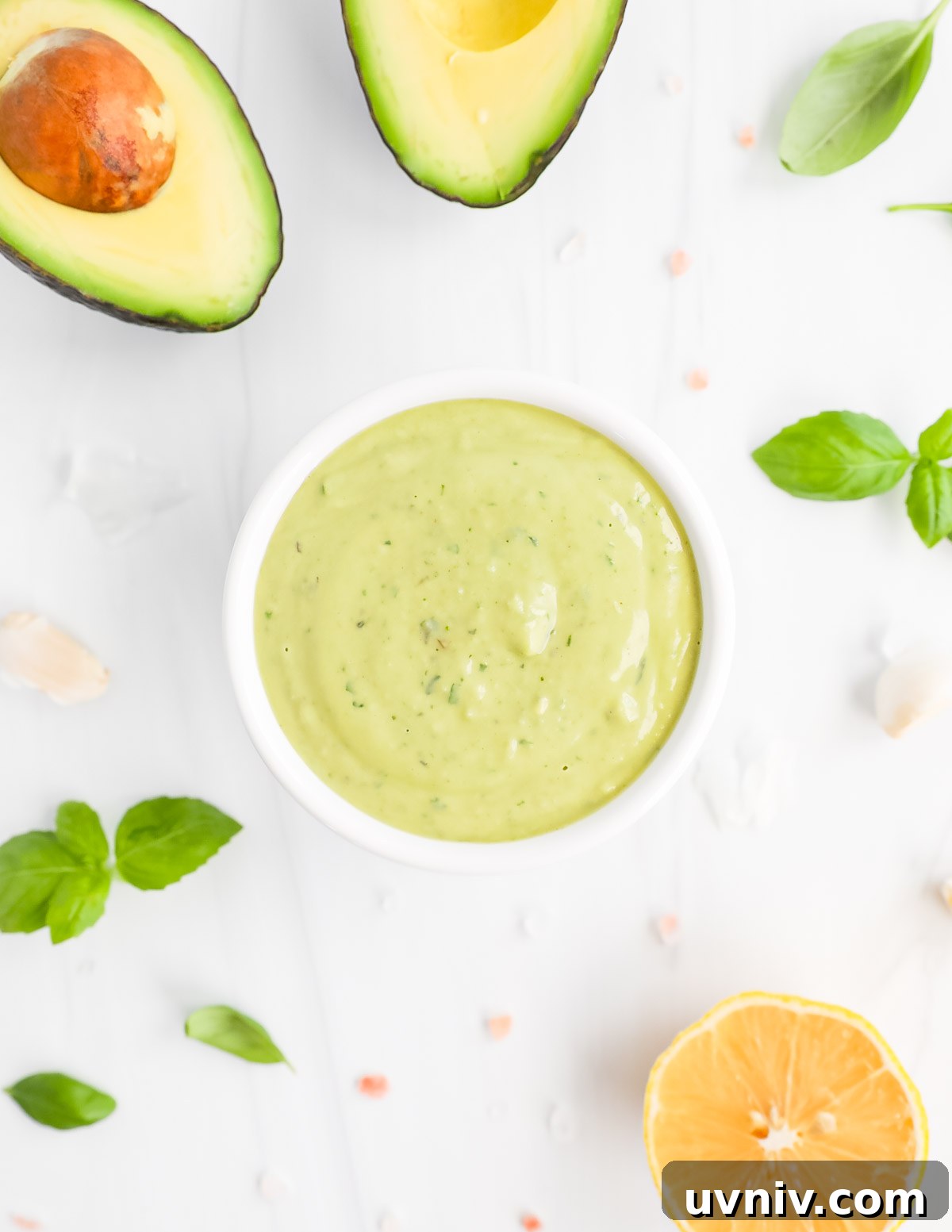 Creamy Lemon Herb Tahini Sauce Recipe for Salad & Dips 2 A creamy green sauce in a small white bowl.