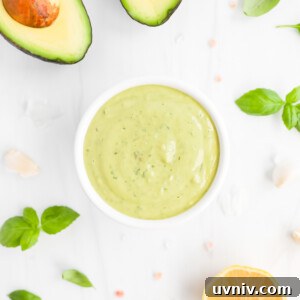 Creamy Lemon Herb Tahini Sauce Recipe for Salad & Dips 12 A small white bowl filled with creamy green sauce.