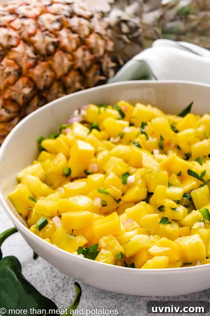 Mango pineapple salsa in a gray dish.