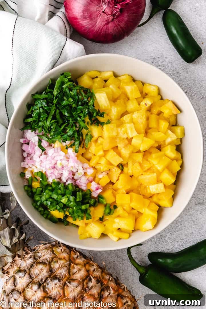 Ingredients for mango pineapple salsa unmixed in a bowl.