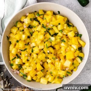 Top down view of fruit salsa with cilantro and lime juice.