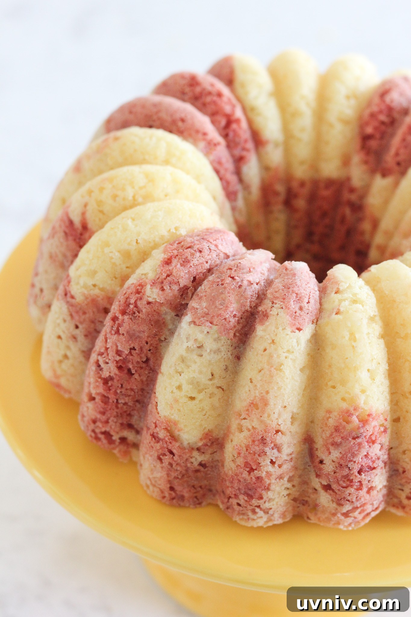 Hawaiian Lava Flow Bundt Cake Recipe: Pineapple Strawberry Swirl 4 Bundt cake being glazed