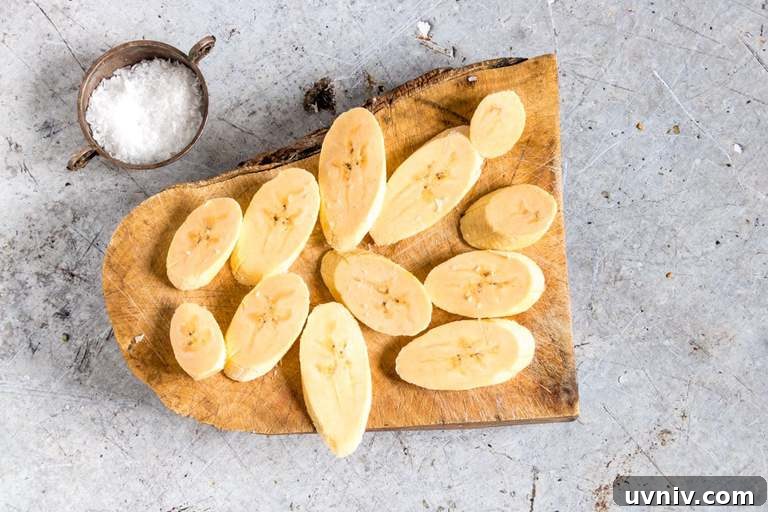 Crispy Fried Plantains Recipe: Sweet and Savory Guide 3 cut plantain slices on a cutting board