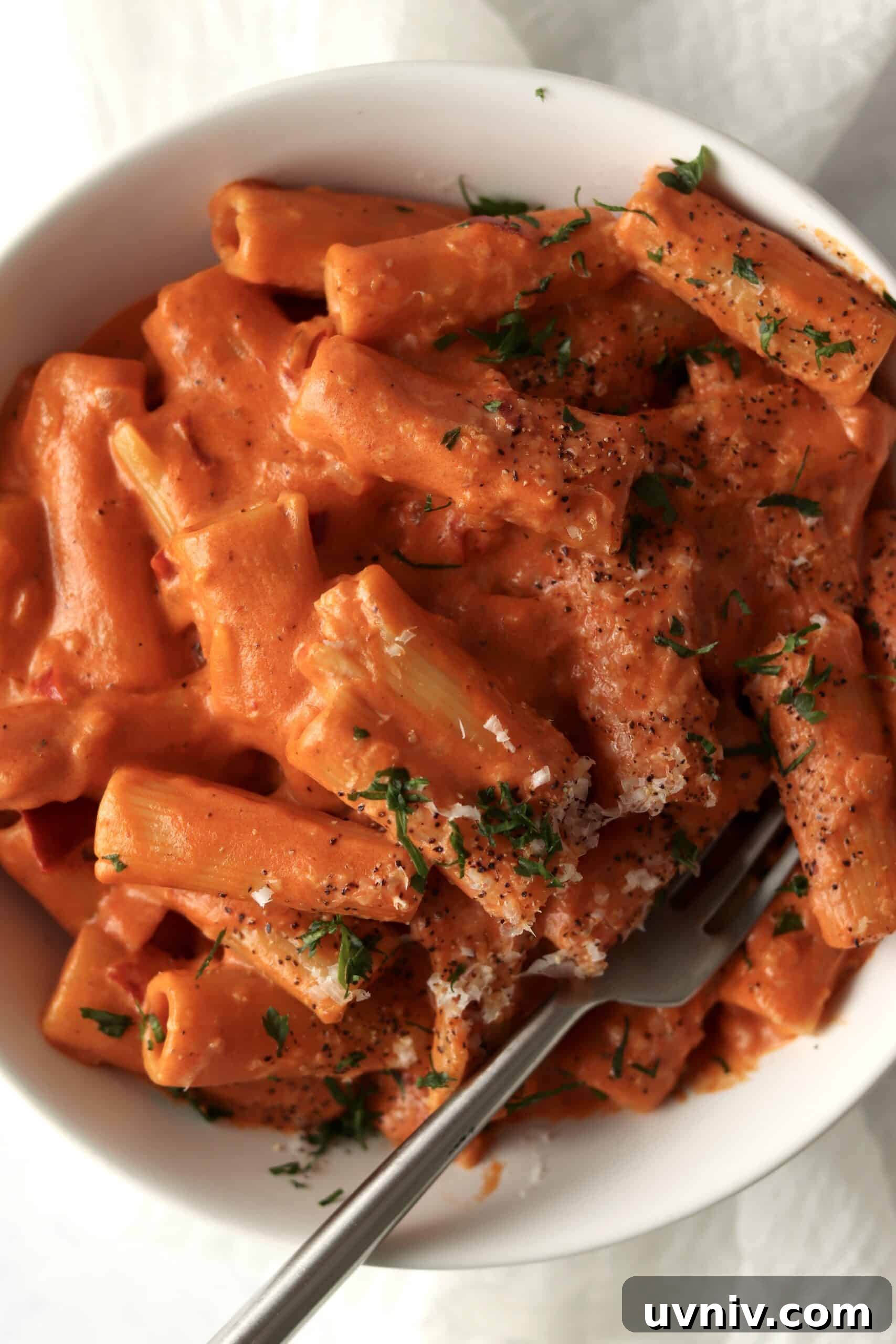 Spicy Rigatoni alla Carbonara — Copycat Restaurant Recipe 8 close up of spicy rigatoni in a bowl with parmesan