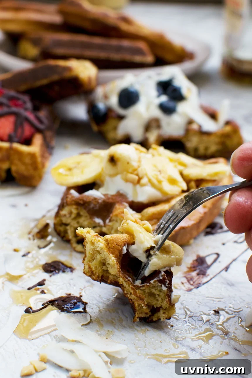 Banana Bread Waffles That Transform Your Weekend Brunch 2 A bite of banana bread waffles on a fork, with more waffles in the background