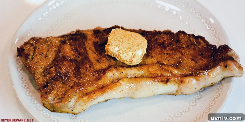 Finished skillet strip steaks with cajun compound butter