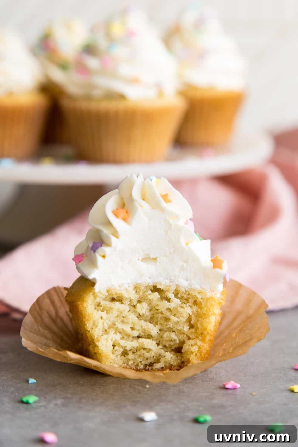 A half eaten vanilla cupcake
