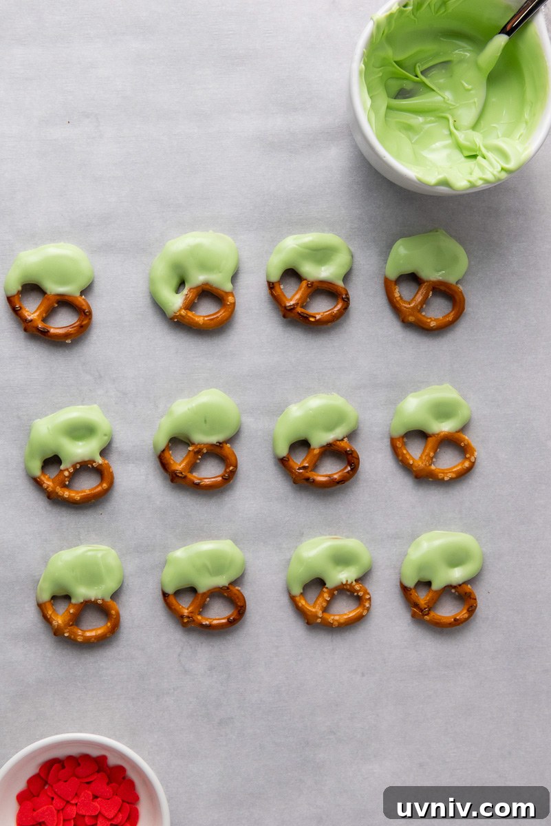 Dipping pretzel in green chocolate
