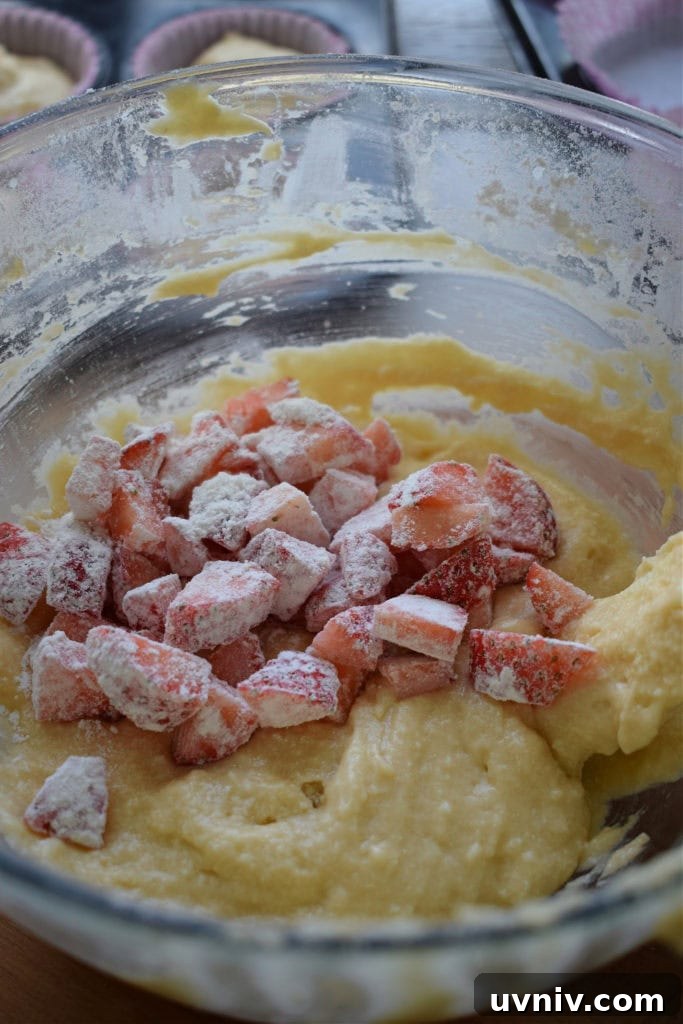 adding strawberries to cake batter