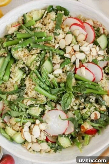 Asparagus quinoa salad in a large ceramic serving bowl.